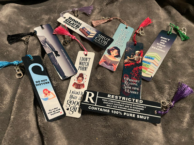 Collection of smut themed bookmarks on a textured surface
