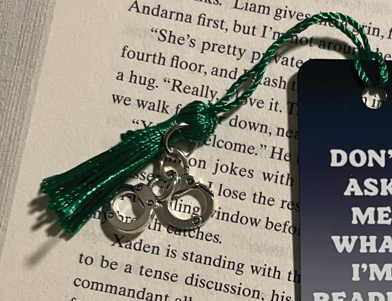 close up view of bookmark tassel with tiny handcuffs charm
